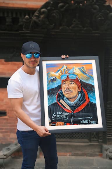 Nims Dai holding portrait